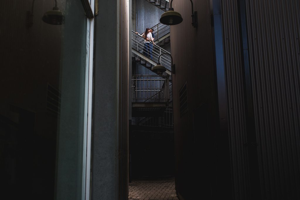 Artistic portrait of a couple in an alleyway at Granville Island