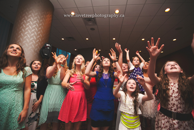 bouquet toss anticipation | fun and fresh wedding photography by www.lovetreephotography.ca