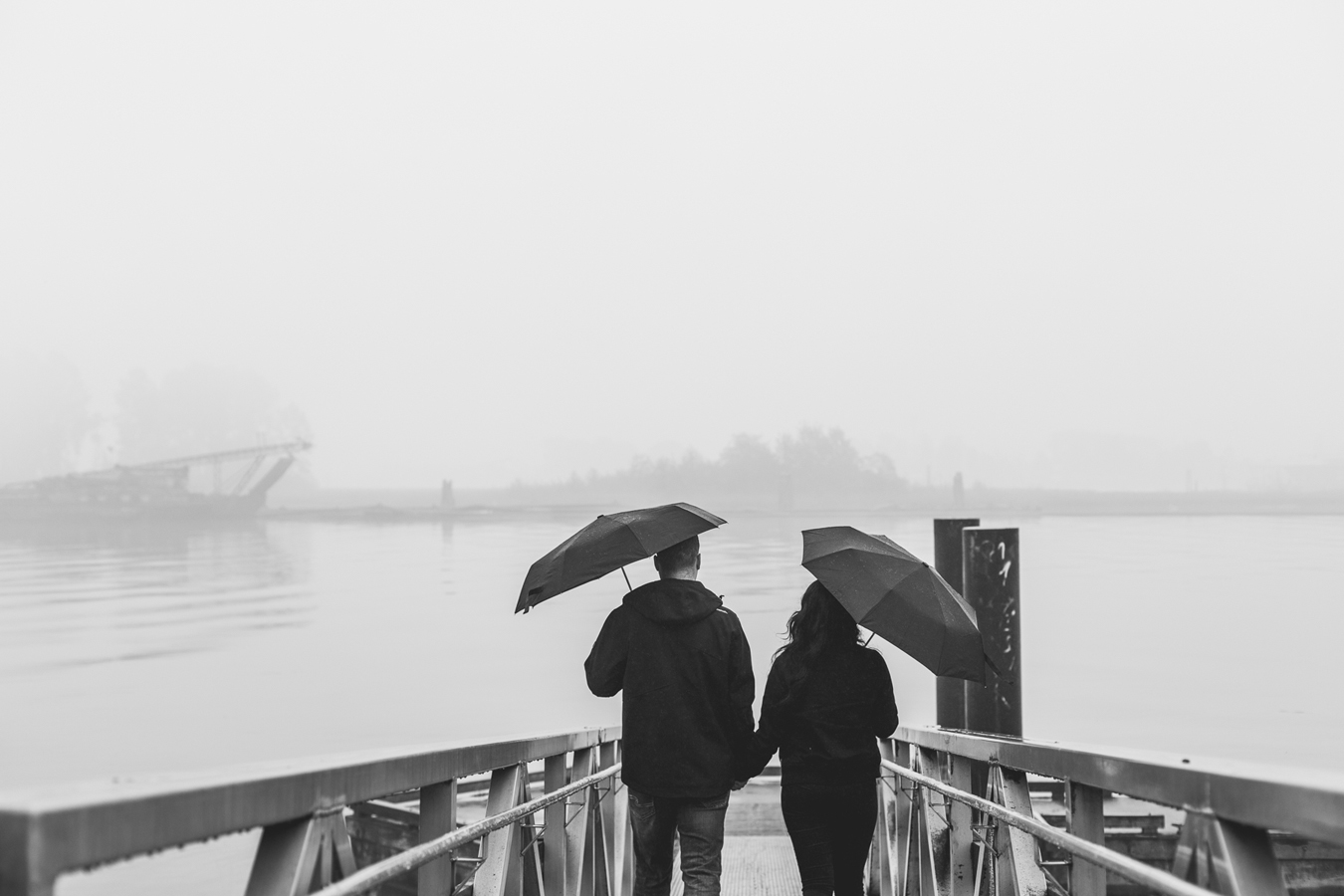 rainy day portrait of a couple on the pier in new westminster