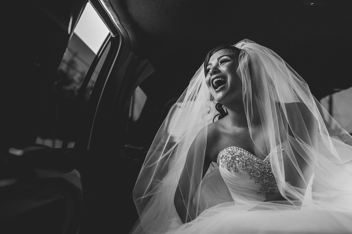 bride laughing in limo