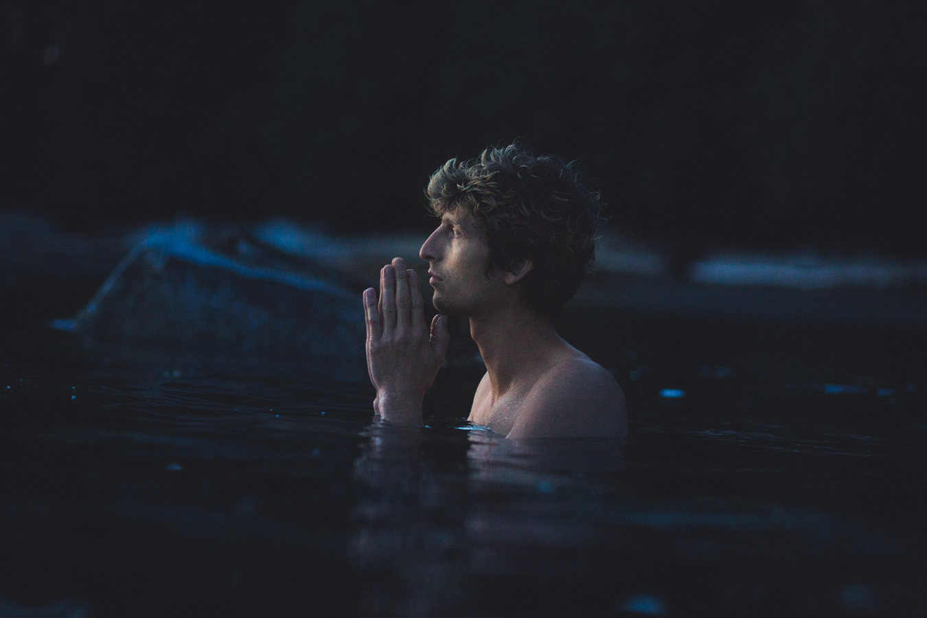 man praying in the water