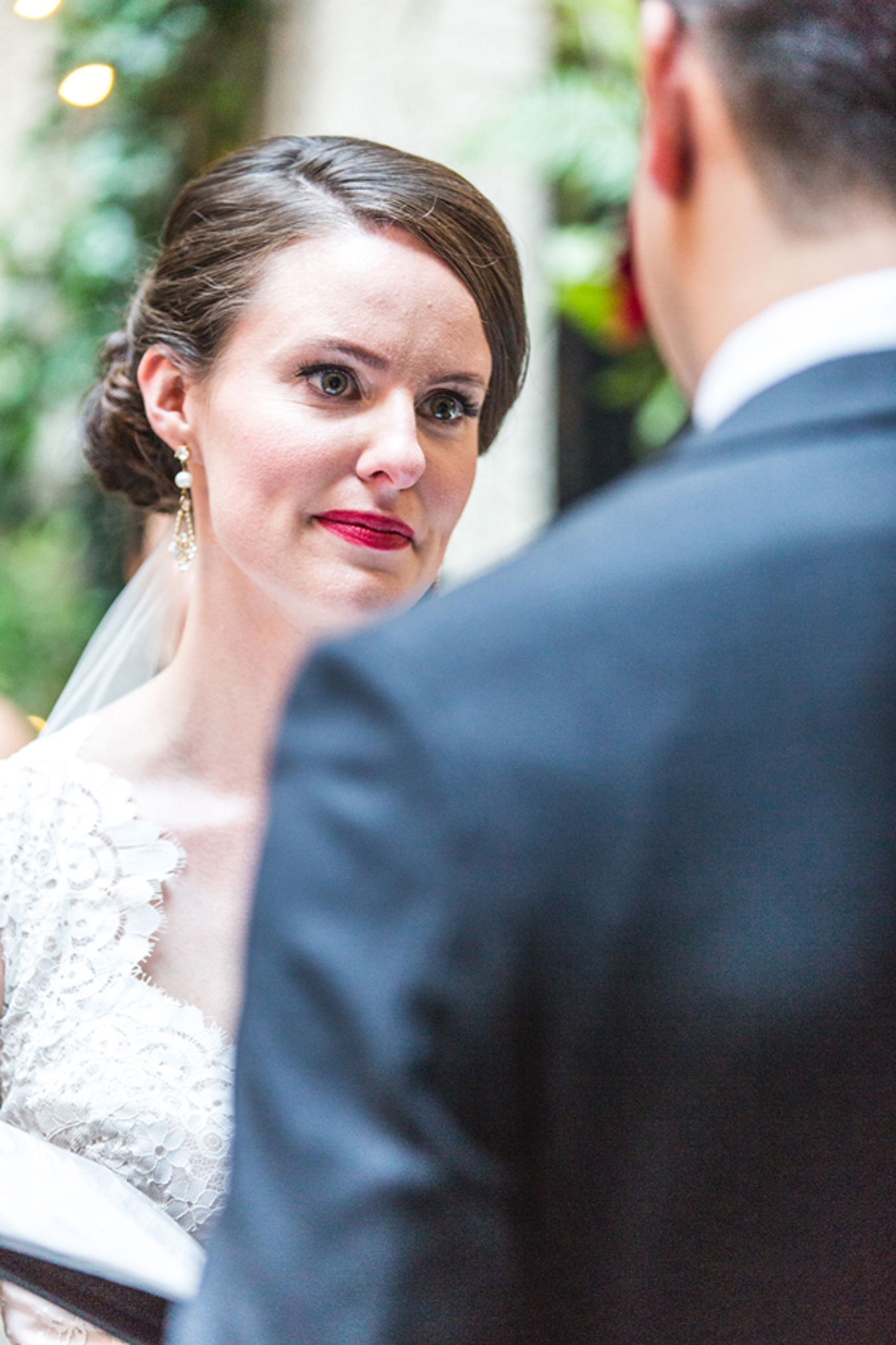 bride's eyes well with tears as she listens to her husband's vows