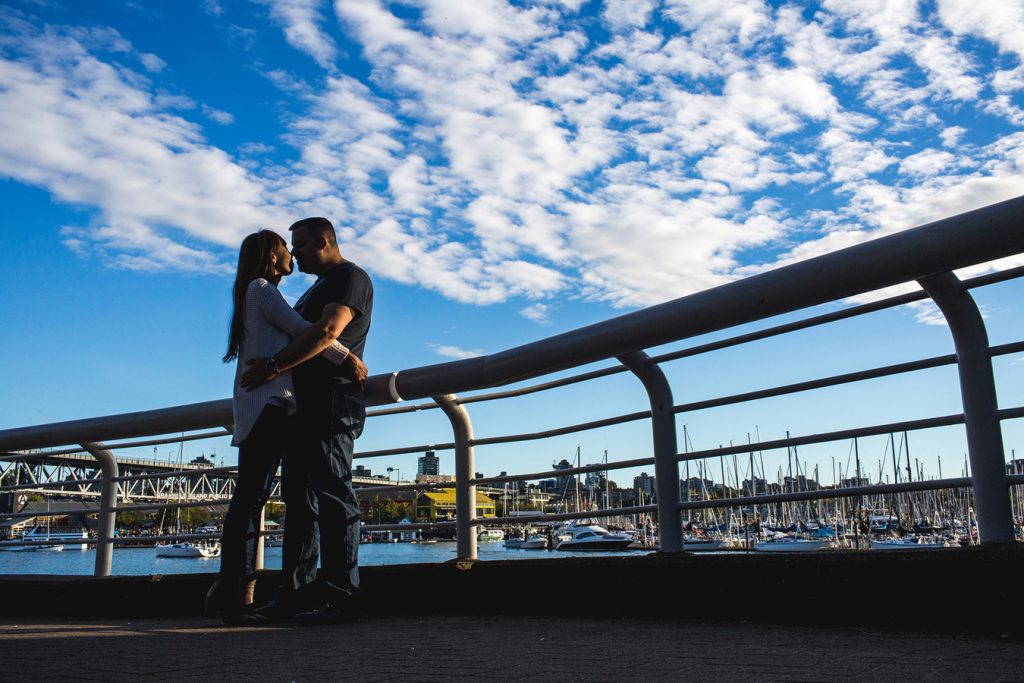 The silhouette of a couple with Granville Island in the background
