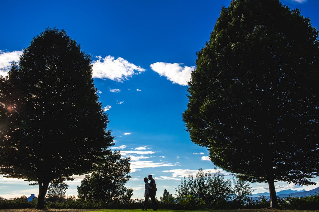A silhouette of a couple against the sky in Vancouver BC