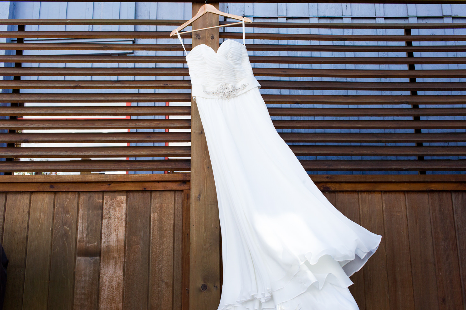 wind blown wedding dress at beach wedding
