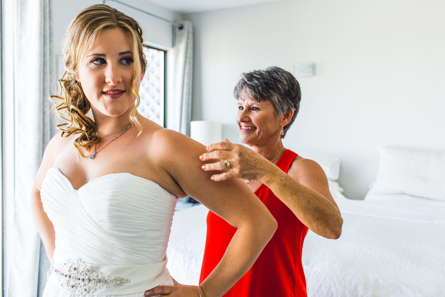 mother helps bride get ready for beach wedding in ladner bc