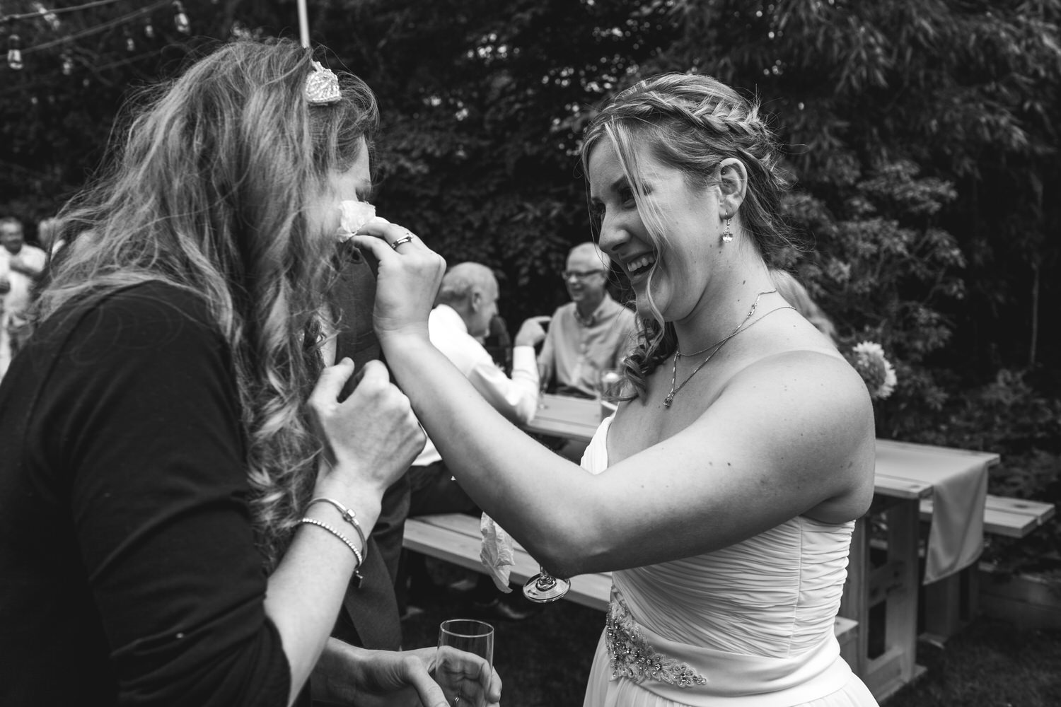 Bride dries her best friend's tears at a wedding