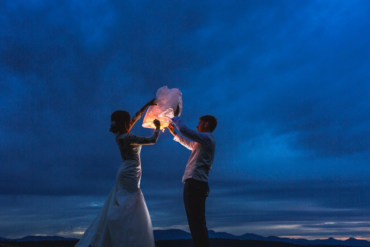 Newlyweds light a wedding lantern