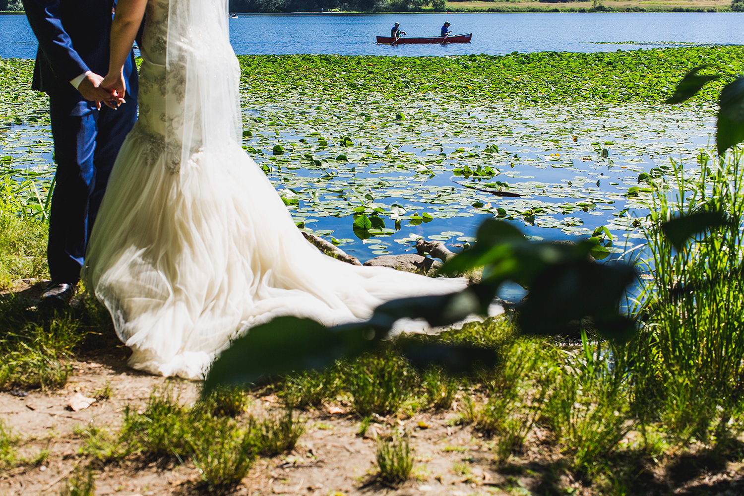 Canoers padde by bride and groom at Deer Lake Park