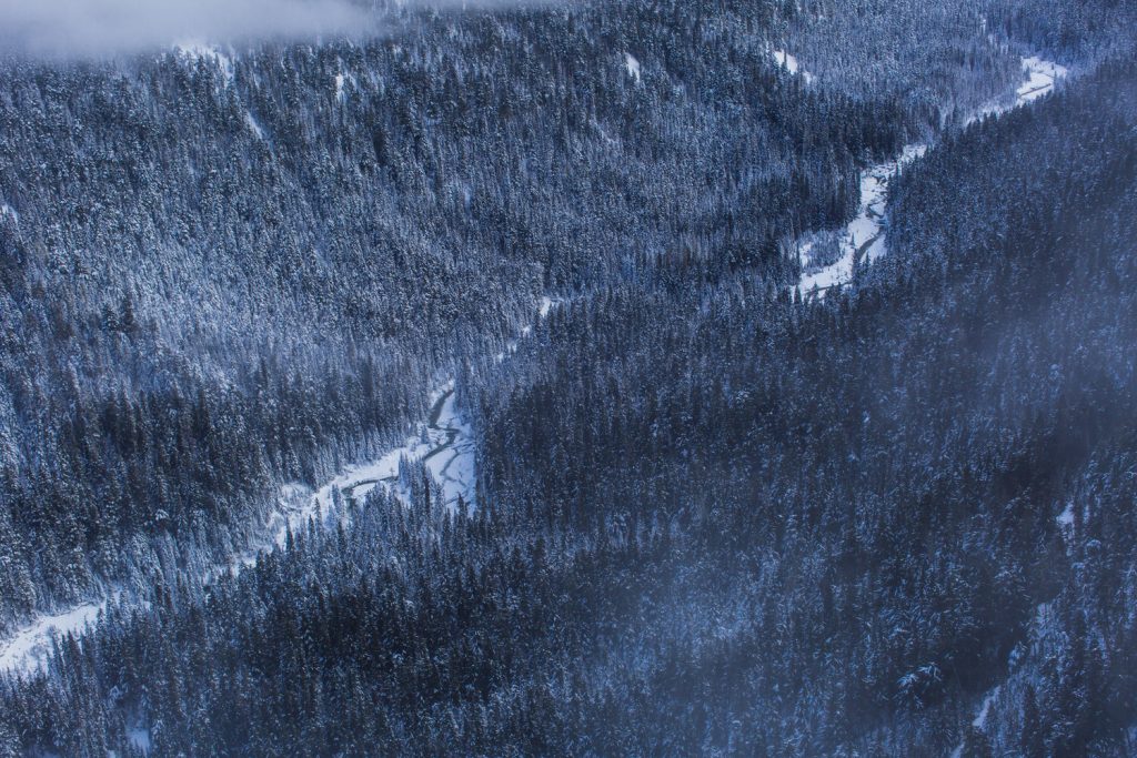 A top downview of a frozen river from the peak to peak gondola in Whistler BC