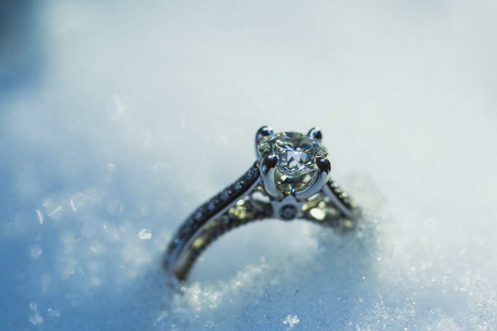 A diamond engagement ring in the snow in Whistler